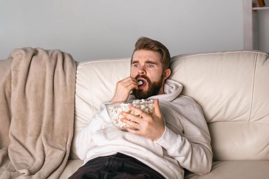 Portrait of guy watching TV series online. Online cinema and video streaming service