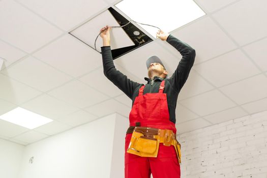 Builder replacing ceiling panel, working, ceiling armstrong.