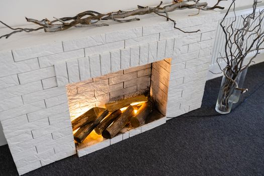 Decorative fireplace on the wall - modern interior. With a white brick