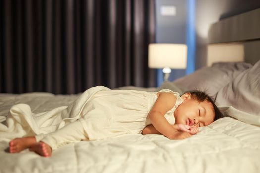 baby sleeping on bed in bedroom at home