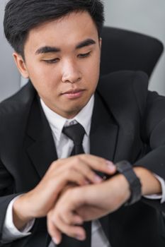 young business man checking time on smart watch 