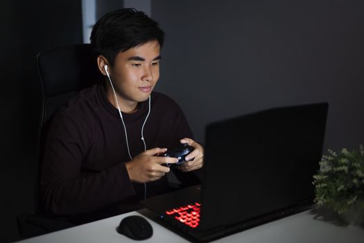 happy young man using joystick to playing games