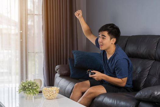 young man playing video games and wins