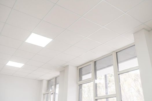 Acoustic ceiling with lighting and light channel window, Acoustic ceiling board texture Sound-proof material, Sound absorber, industry construction concept background black and white tone.