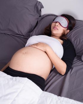 pregnant woman sleeping on bed in the bedroom at home