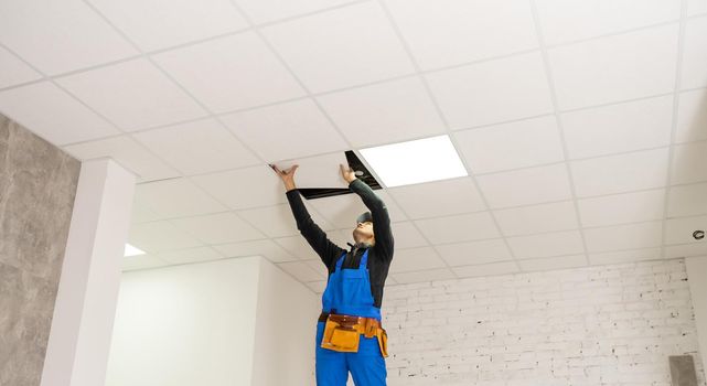 Ceiling installation with expert technicians In the room that is in the construction process