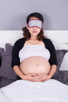 pregnant woman sleeping on bed in the bedroom at home