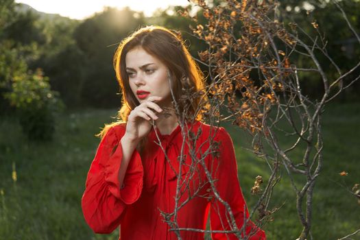 attractive woman in red dress outdoors fresh air summer. High quality photo