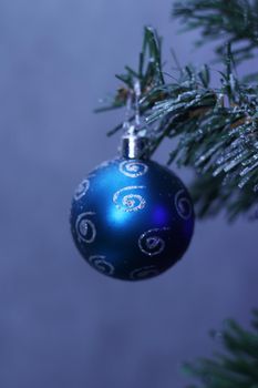 blue bauble hanging on the Christmas tree