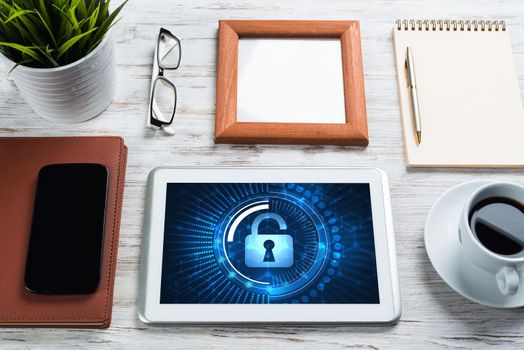 Business workplace with office stuff and tablet with padlock icons on screen