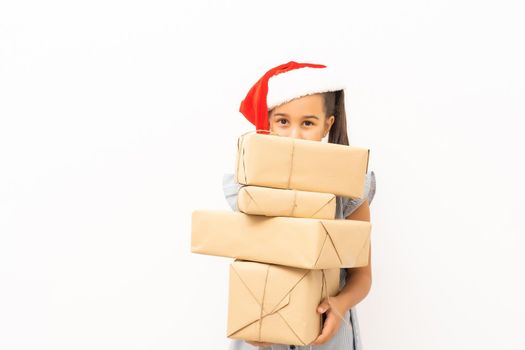 little girl in santa hat with boxes on white background