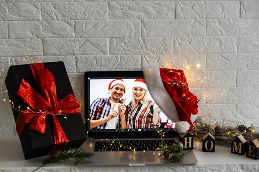 Laptop on the christmas table. Video call with the family in times of coronavirus