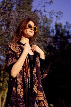 pretty woman wearing sunglasses outdoors fashion nature. High quality photo