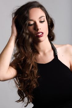 Portrait of brunette woman with long hair wearing black t-shirt