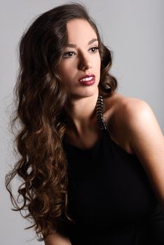 Portrait of brunette woman with long hair wearing black t-shirt