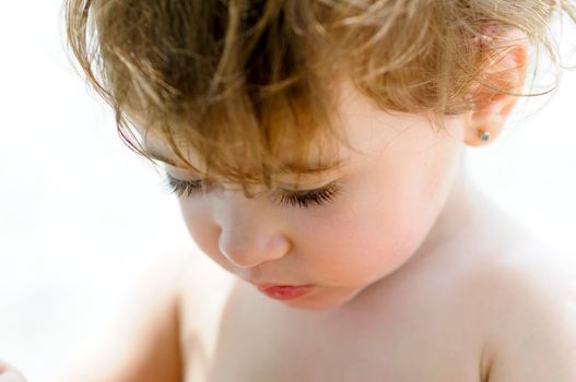 Close-up potrait of adorable little girl outdoors.