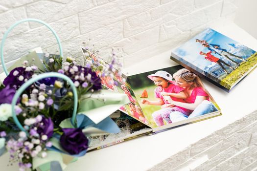 album photo book with the inscription with a decor next to flowers, view from above.