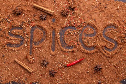 Top view of the inscription spices made from red capsicum ground pepper and cinnamon on the table. Spicy food and oriental cuisine concept