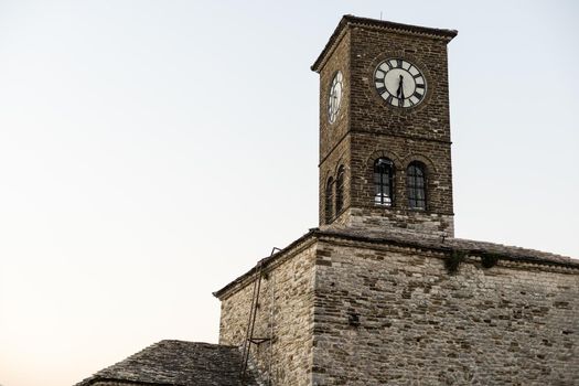 Panoramic view to Gjirokastra castle with the wall, tower and Clock in Gjirokaster, Albania.