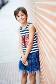 Little girl, eight years old, having fun in an urban park.