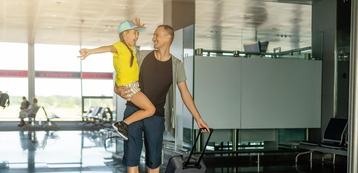Little girl with her father at airport.
