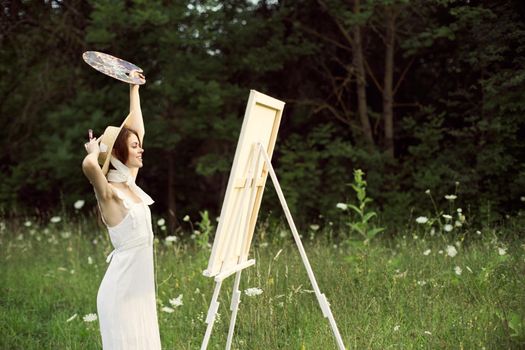 cheerful woman outdoors drawing art landscape hobby. High quality photo