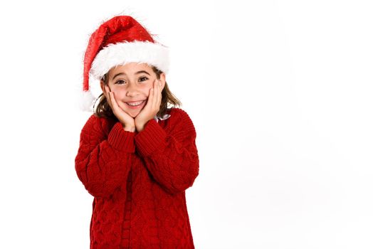 Adorable little girl wearing santa hat isolated on white background. Winter clothes for Christmas