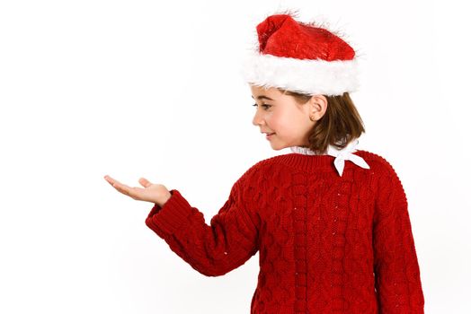 Adorable little girl wearing santa hat isolated on white background. Winter clothes for Christmas