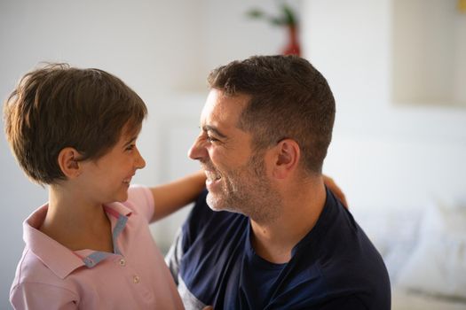 Middle-age father and her little daughter having fun at home. Man spending free time with her daughter.