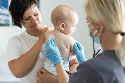 doctor with newborn on a white.