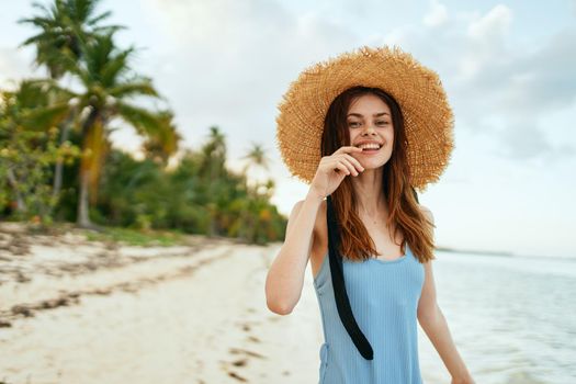 cheerful woman in a beach hat by the ocean island summer. High quality photo