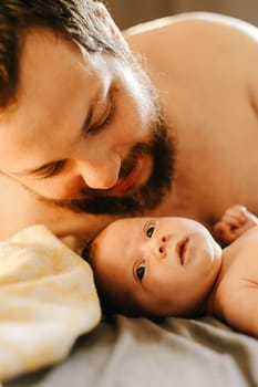 Close up portrait of caucasian father holding newborn baby. Concept of tender family photo session with little kids, new life and happiness, parenthood. Selective focus