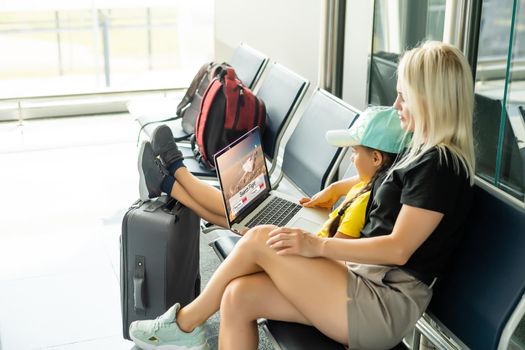 young woman using laptop computer at airport.