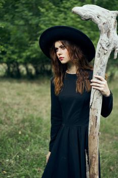 woman in witch costume fantasy magic forest posing. High quality photo