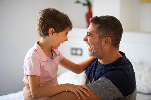 Middle-age father and her little daughter having fun at home. Man spending free time with her daughter.