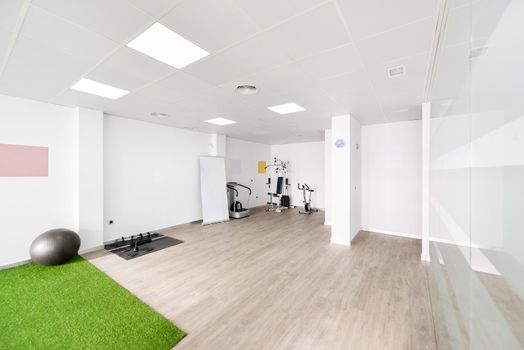 Interior of physiotherapy clinic with equipment for rehabilitation. Physical therapy center.