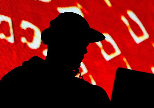 DJ, black silhouette of a man in a cap and headphones on a red background or appeal, propaganda.
