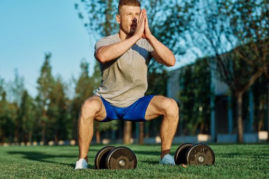 male athlete park with dumbbells doing CrossFit exercise. High quality photo