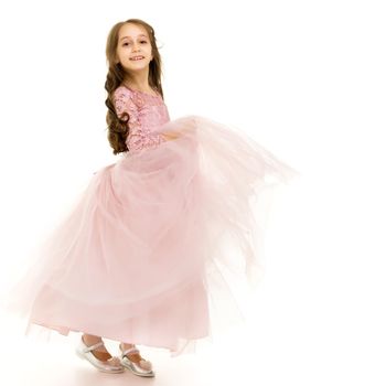 Beautiful little girl in an elegant dress in full growth. The concept of style and fashion. Layout for magazine cover. Isolated on white background.