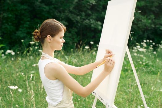 women outdoors near easel creative art drawing. High quality photo