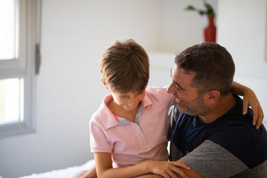 Middle-age father and her little daughter having fun at home. Man spending free time with her daughter.