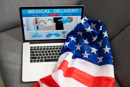 Medical service concept. Laptop and stethoscope on USA flag background