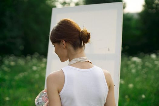 woman artist outdoors easel drawing creative landscape. High quality photo