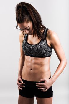 Young sport sexy fitness woman body posing on white background.