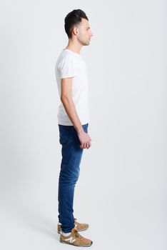 Portrait of a smart serious young man standing against white background