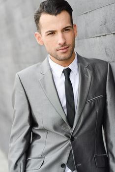 Portrait of a young businessman near a office building