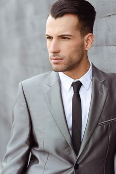 Portrait of a young businessman near a office building