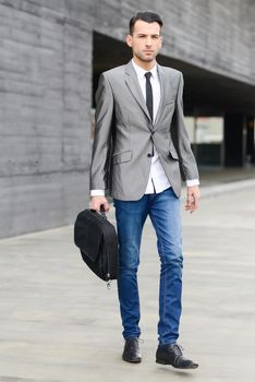 Portrait of a young businessman near a office building