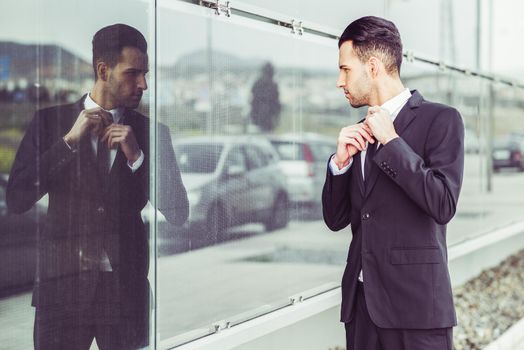 Portrait of a young businessman near a office building