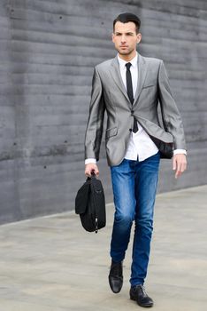 Portrait of a young businessman near a office building
